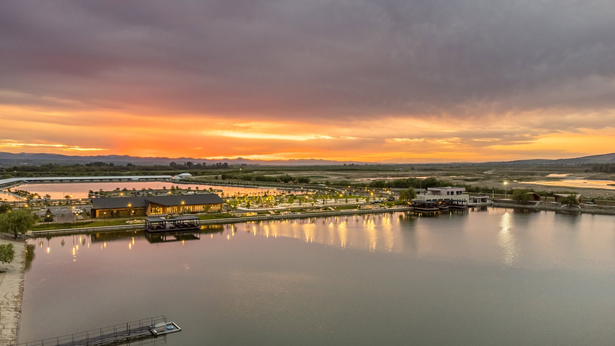 Golden sunset and reflected lights over the lake at ARCA Resort