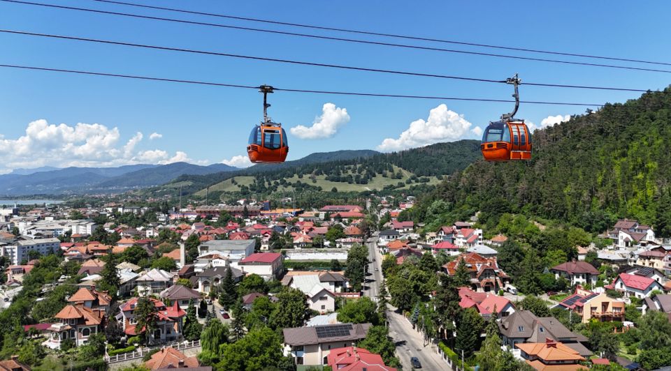 Orange cable cars above Piatra Neamț and the surrounding hills